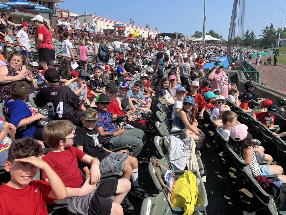 students in stands at baseball game