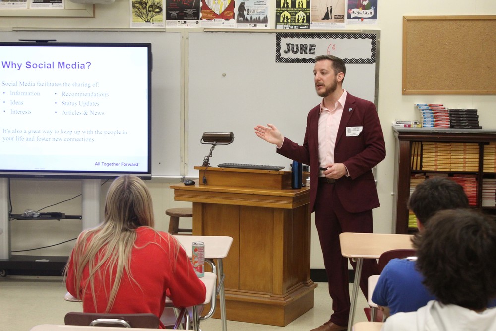 man giving presentation to classroom of high school students